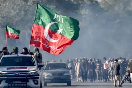 PTI workers marching with flags during a protest as part of the 5 August protest plan